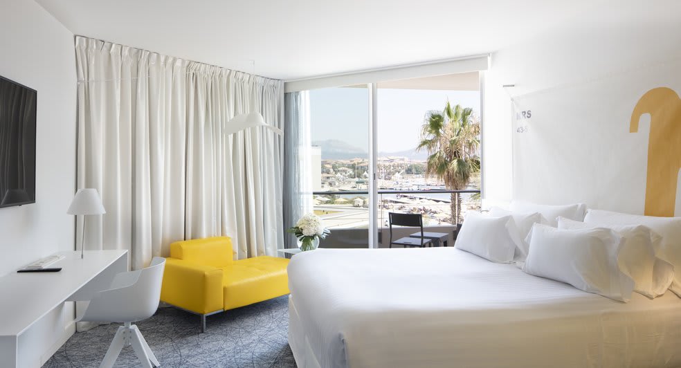 Empty Marseille hotel room with large window and Mediterranean sea view