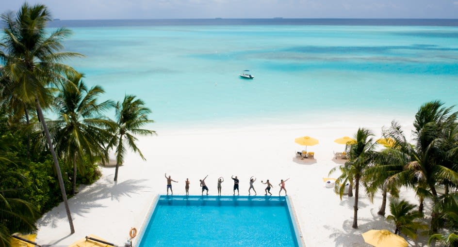 Guests enjoying by the poolside at Niyama Private Islands Maldives