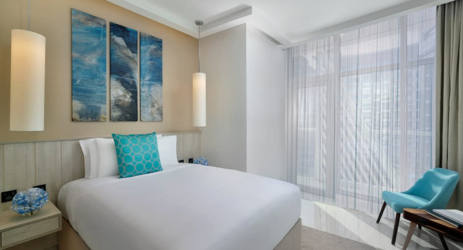 Bedroom of the superior studio with ocean painting at NH Collection Dubai The Palm