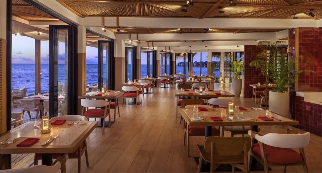 Ocean-view dining setup at Sea Fire Salt, Anantara Dhigu Maldives.