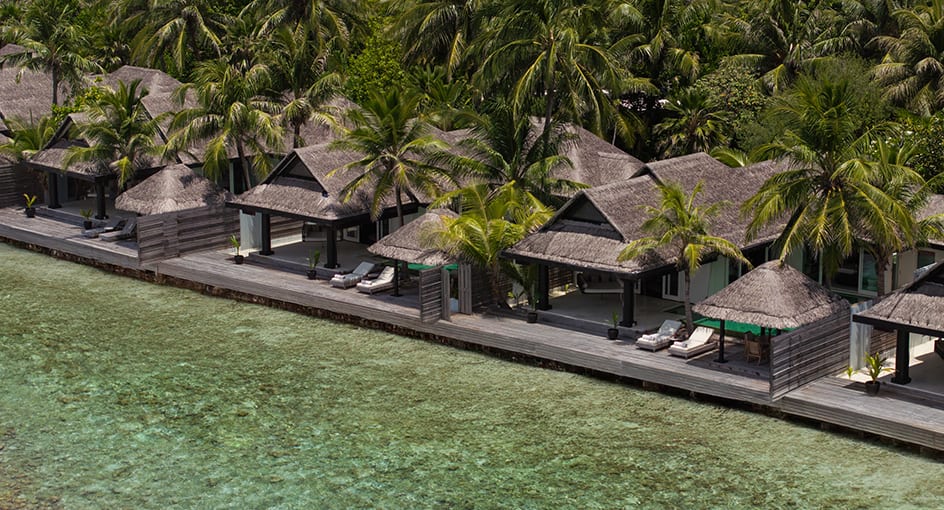 Aerial view of ocean houses lined along the lagoon at Naladhu Private Island Maldives