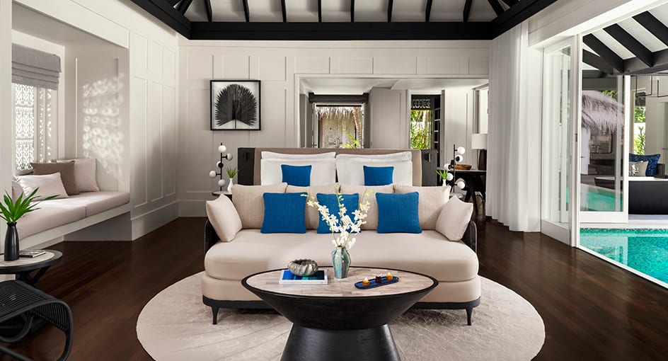 Spacious villa interior featuring stylish seating and tropical surroundings at Naladhu Private Island Maldives.