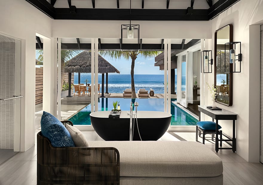 Luxurious bathroom with freestanding bathtub and private pool overlooking the ocean at Naladhu Private Island Maldives.