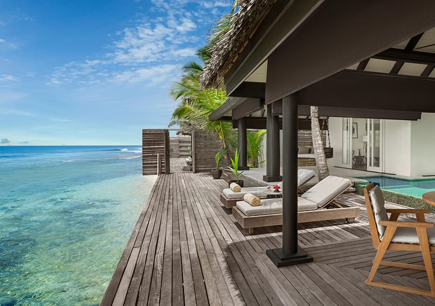 Luxury villa terrace overlooking the turquoise lagoon at Naladhu Private Island Maldives.