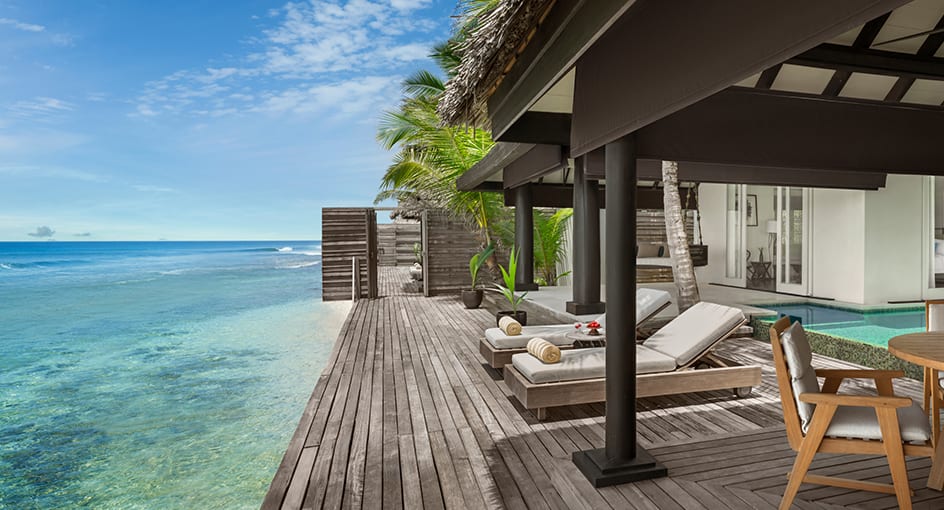 Luxury villa terrace overlooking the turquoise lagoon at Naladhu Private Island Maldives.