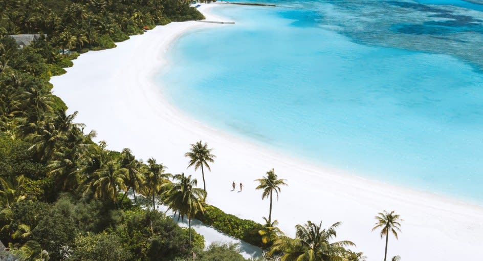 Aerial view of couple walking on the long beach a Niyama Private Islands Maldives
