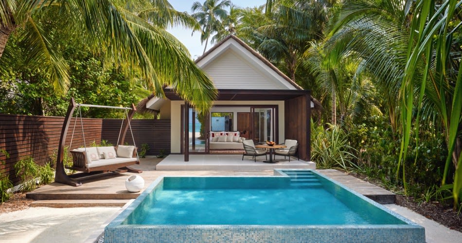 Luxury beach villa with private pool at Niyama Private Islands Maldives, set in lush tropical surroundings with beach access.