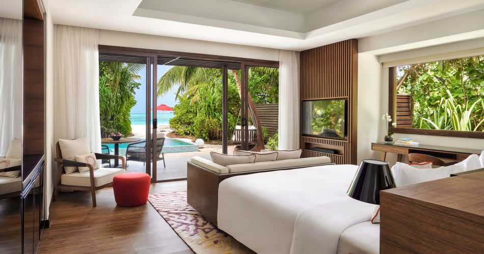 Spacious Deluxe Beach Pool Villa bedroom at Niyama Private Islands Maldives with ocean views, private pool access, and tropical garden setting.