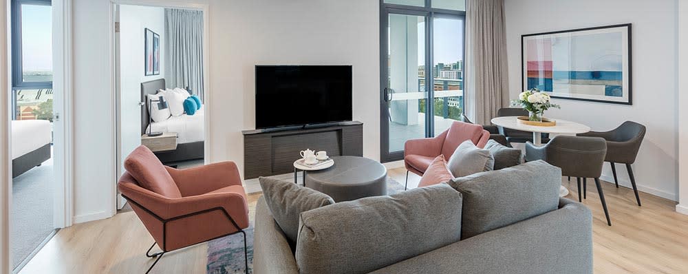 Two Bedroom Suite Living equipped with a cosy seating are with Smart TV