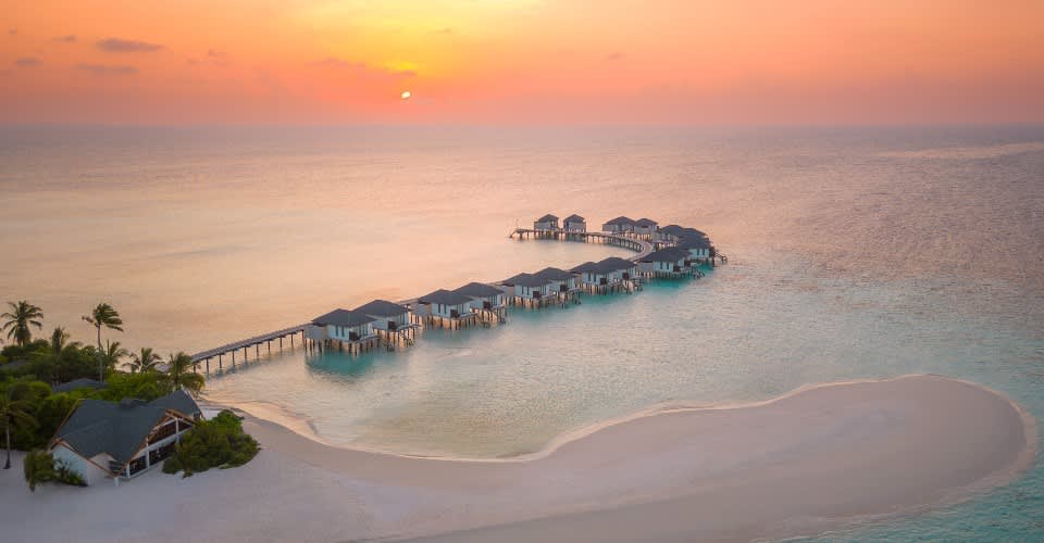 Aerial view of NH Collection Maldives Havodda Resort during sunset