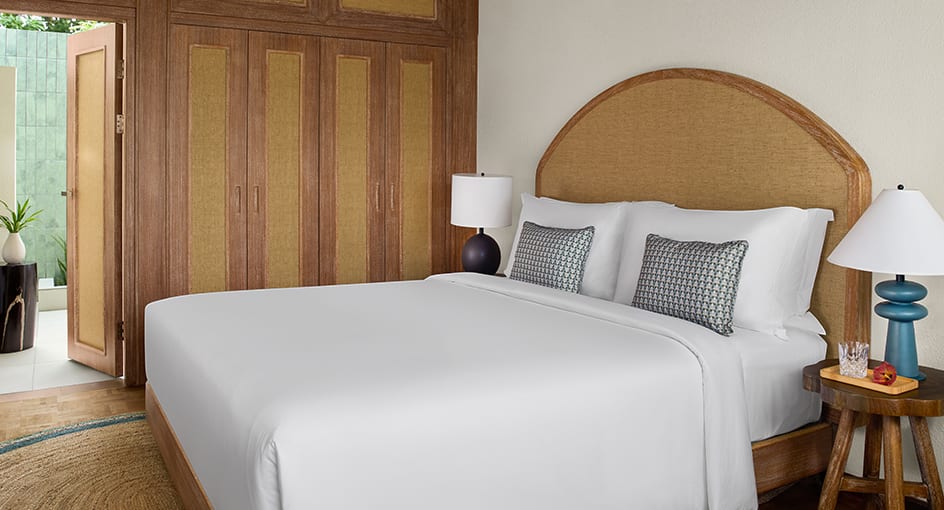 Guest room at NH Collection Maldives Reethi Beach featuring modern island design and natural wood finishes