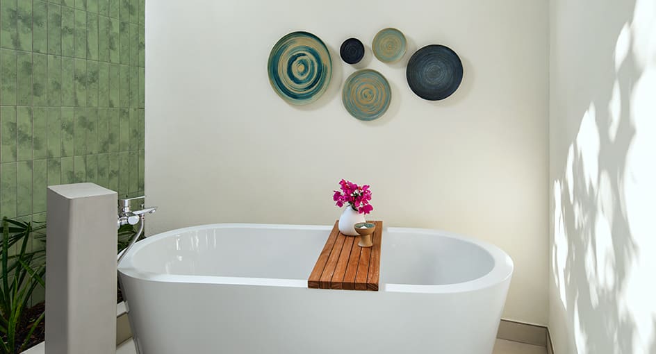 Guest room bathroom at NH Collection Maldives Reethi Beach with freestanding bathtub and modern island design