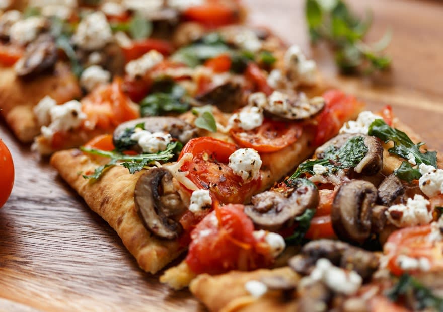 Freshly flatbread pizza topped with vegetables and cheese at NH Collection Maldives Reethi 