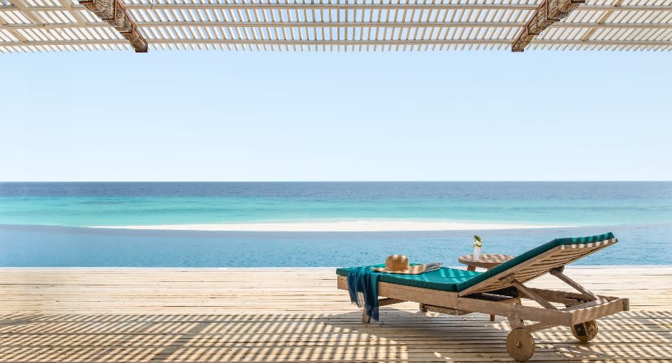 Beachfront sun loungers at NH Collection Maldives Reethi Beach overlooking the turquoise Indian Ocean