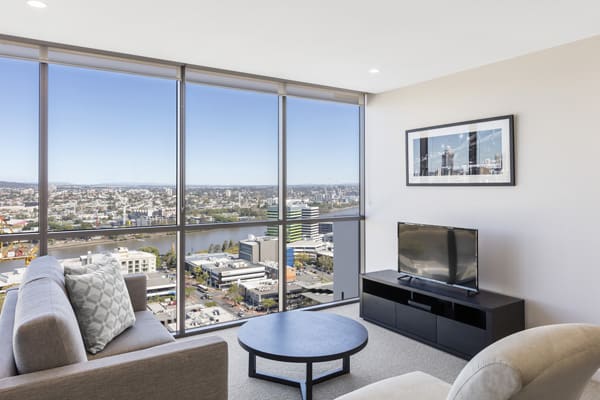 big living room with large windows and great views of Brisbane River at The Milton Brisbane hotel