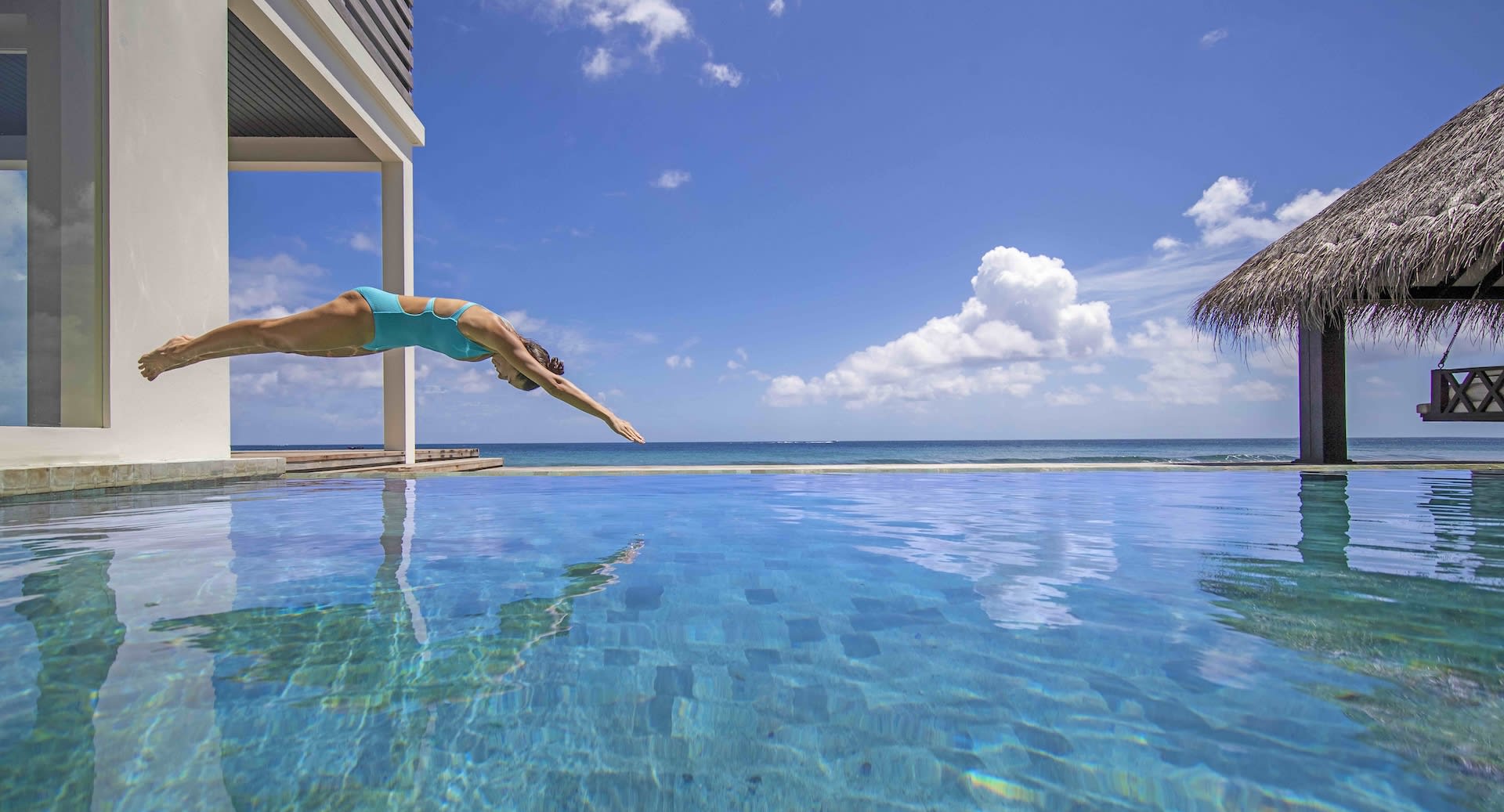 Swimming in pool villa at Naladhu Maldives
