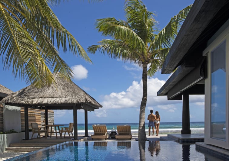 Couple enjoying ocean views from the private deck of an Ocean House with pool at Naladhu Private Island Maldives