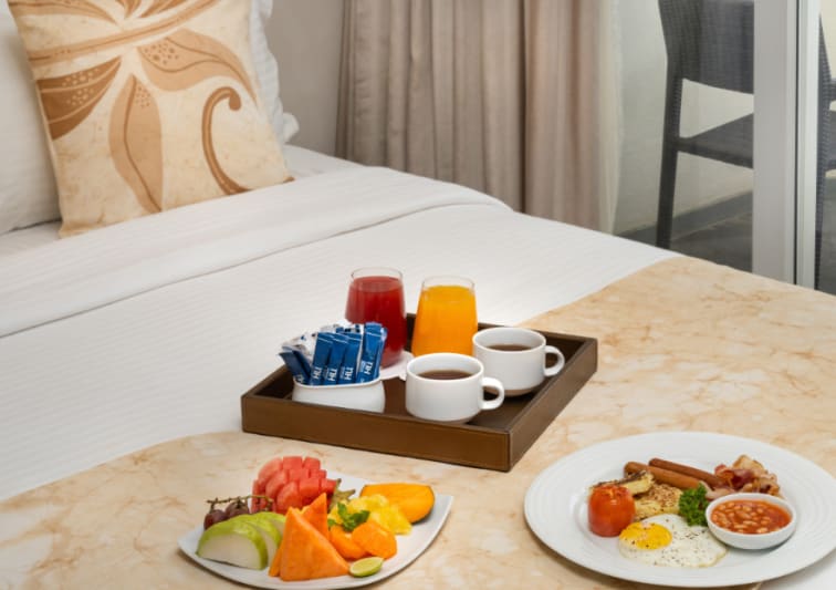 In room dining breakfast tray on bed