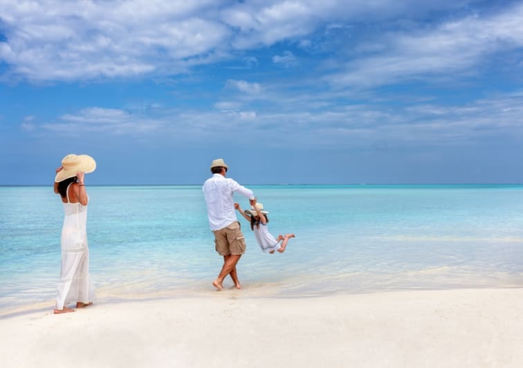 Family enjoying a Maldives beach holiday – Family Getaway offer at NH Collection Maldives Reethi Resort