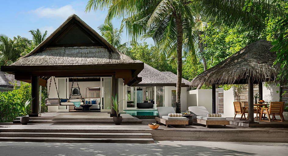 Open-air living and dining spaces of a luxury Maldives beach residence at Naladhu Private Island Maldives