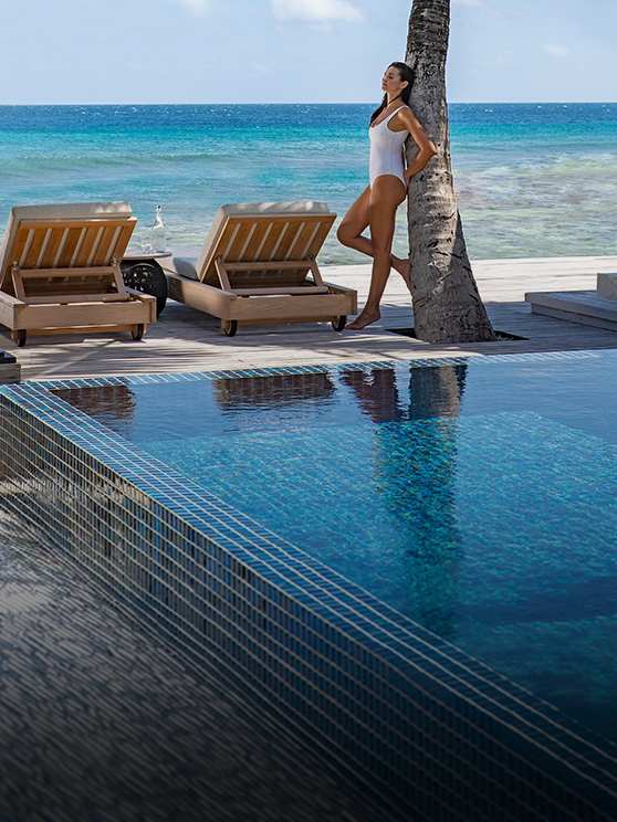 Guest enjoying the view and privacy of the Two Bedroom Beach Pool Residence at Naladhu Private Island Maldives