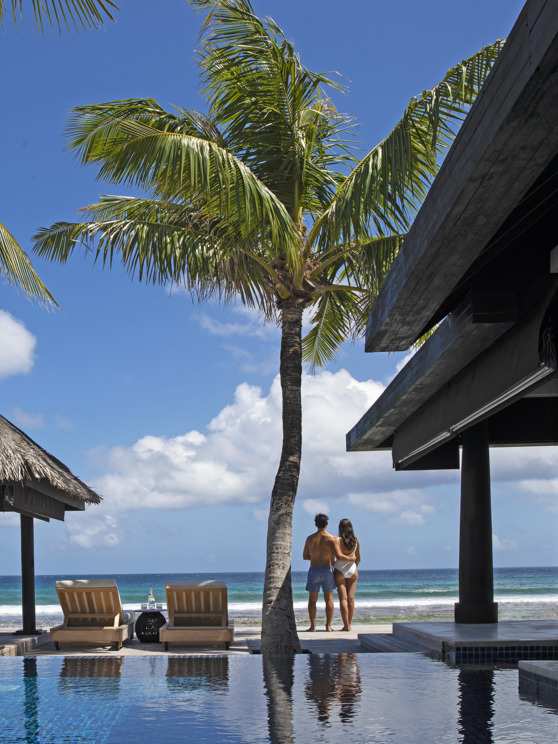 Couple enjoying ocean views from the private deck of an Ocean House with pool at Naladhu Private Island Maldives