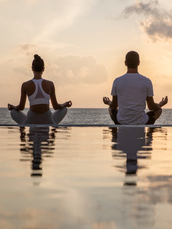 Sunrise yoga practice at Naladhu Private Island Maldives