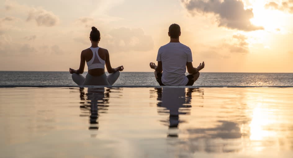Sunrise yoga practice at Naladhu Private Island Maldives