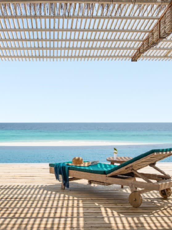 Beachfront sun loungers at NH Collection Maldives Reethi Beach overlooking the turquoise Indian Ocean