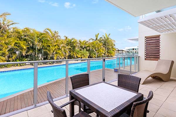 Port Stephens resorts courtyard with table reclining chair and blue skies at oaks pacific blue resort hotel NSW