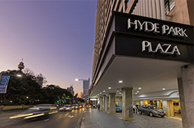 Exterior image of car parking outside hotel in Sydney with Hyde Park Plaza sign