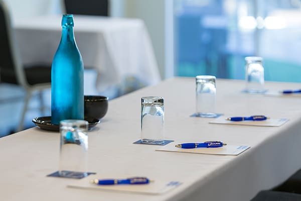 row of pens on notepads on table in conference room in Coolangatta at Oaks Calypso Plaza resort on Gold Coast, Australia