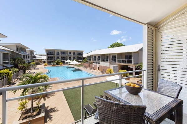 aerial view of the best hotels Broome has with vegetarian meal on table on private balcony and view of private swimming pool at Oaks Broome, Western Australia